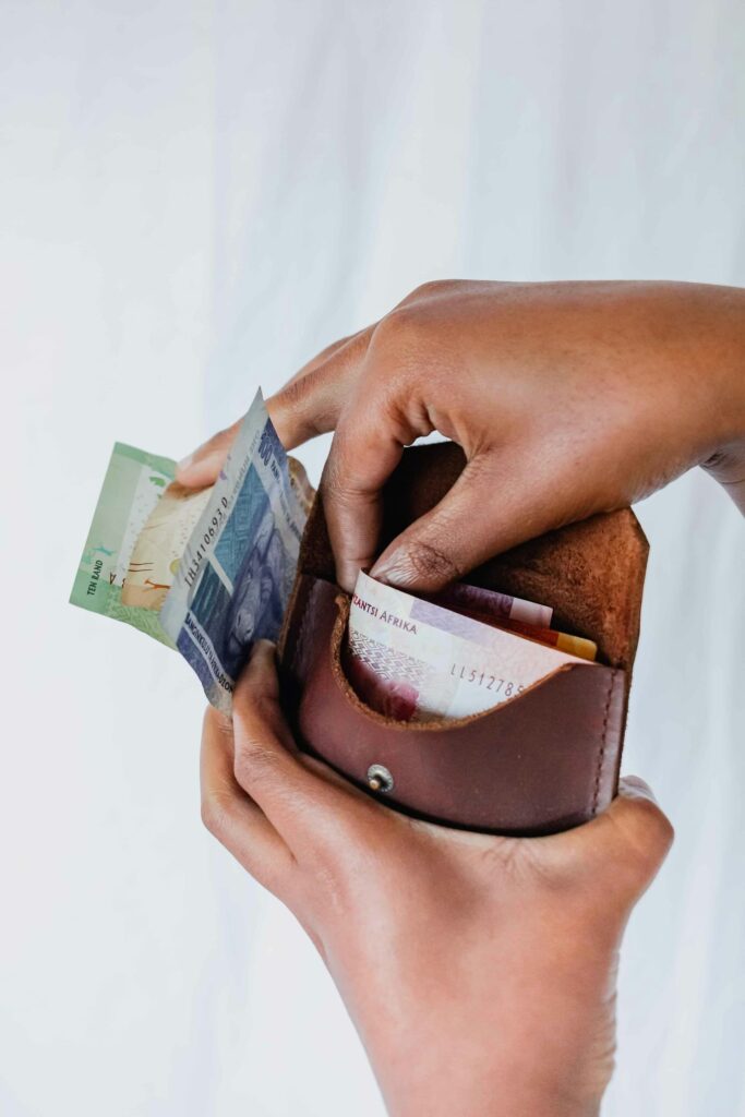 Woman putting banknotes in a wallet
