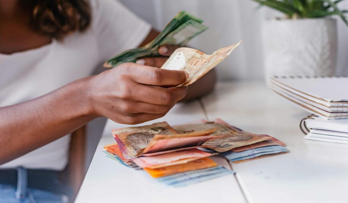 An African counting cash. Remittance Payout Options