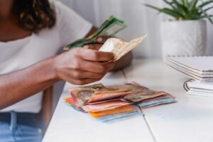 An African counting cash. Remittance Payout Options