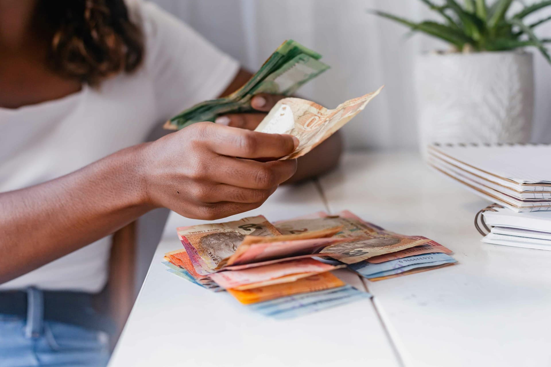 An African counting cash. Remittance Payout Options
